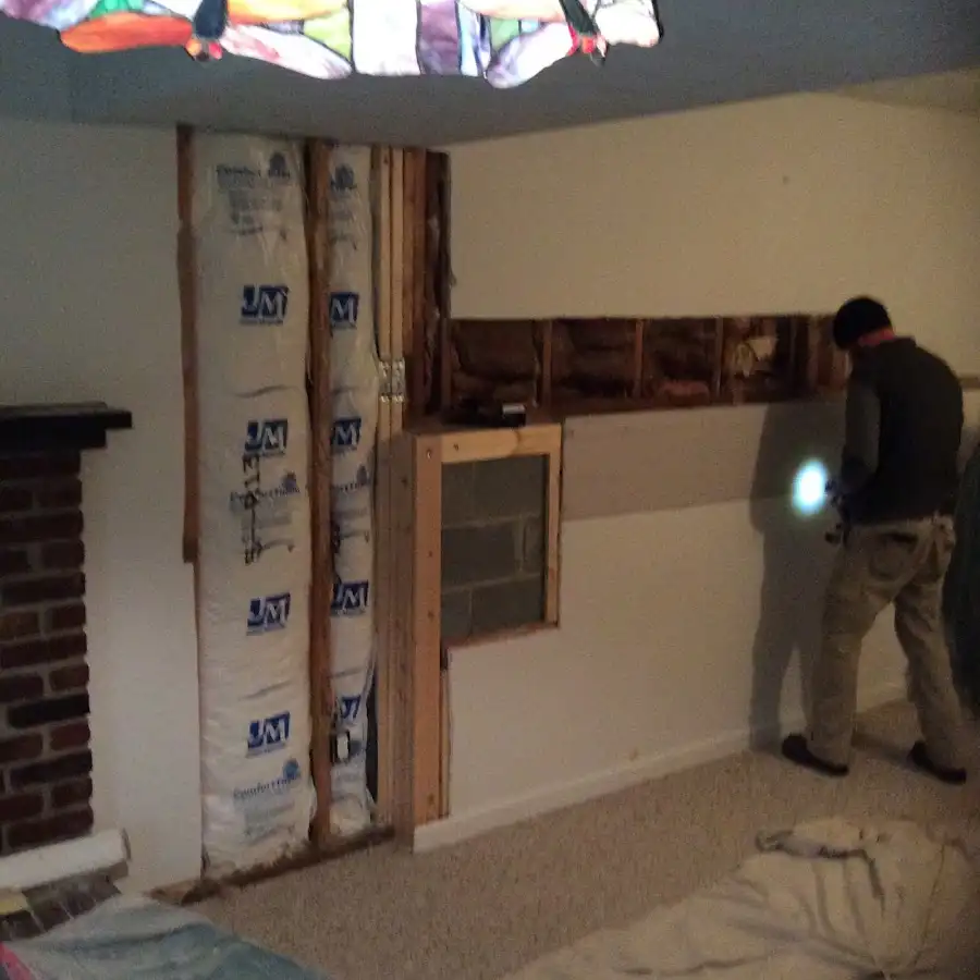 Restoration technician inspecting water damage in Denver